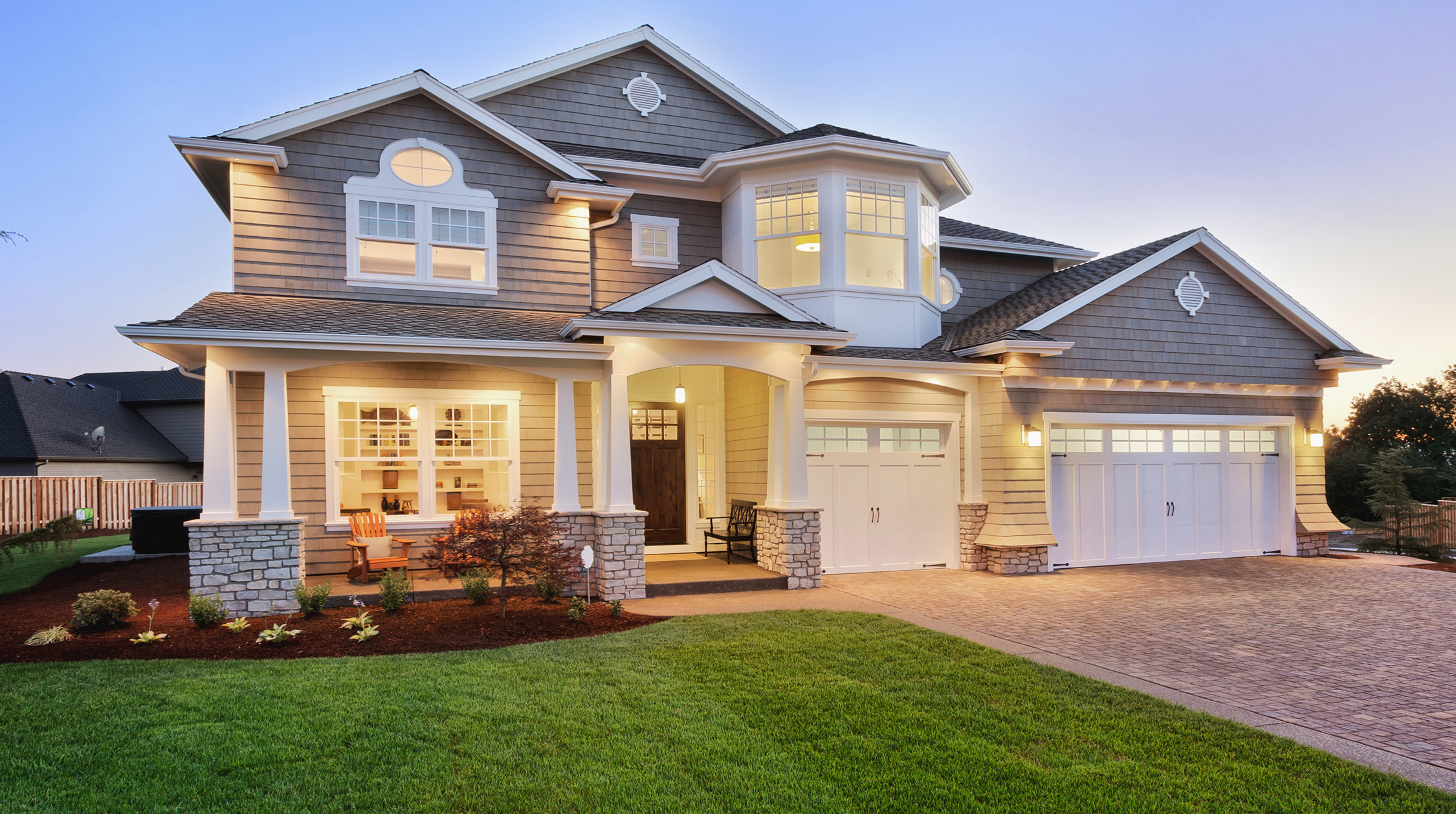 grey home with lawn and wooden door