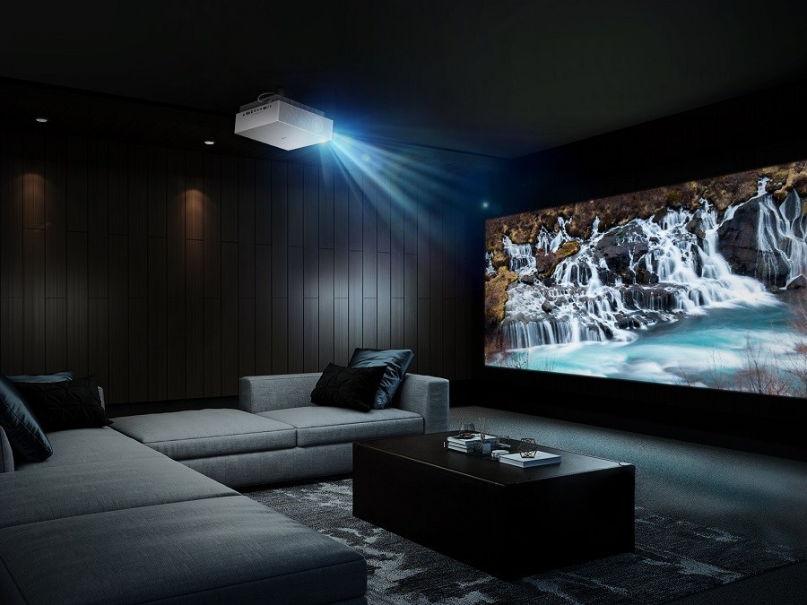 Luxury home theater installation with sophisticated seating and stunning video on the screen. 