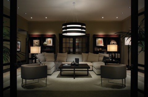 Living room with lights dimmed using Lutron dimmers to save energy.
