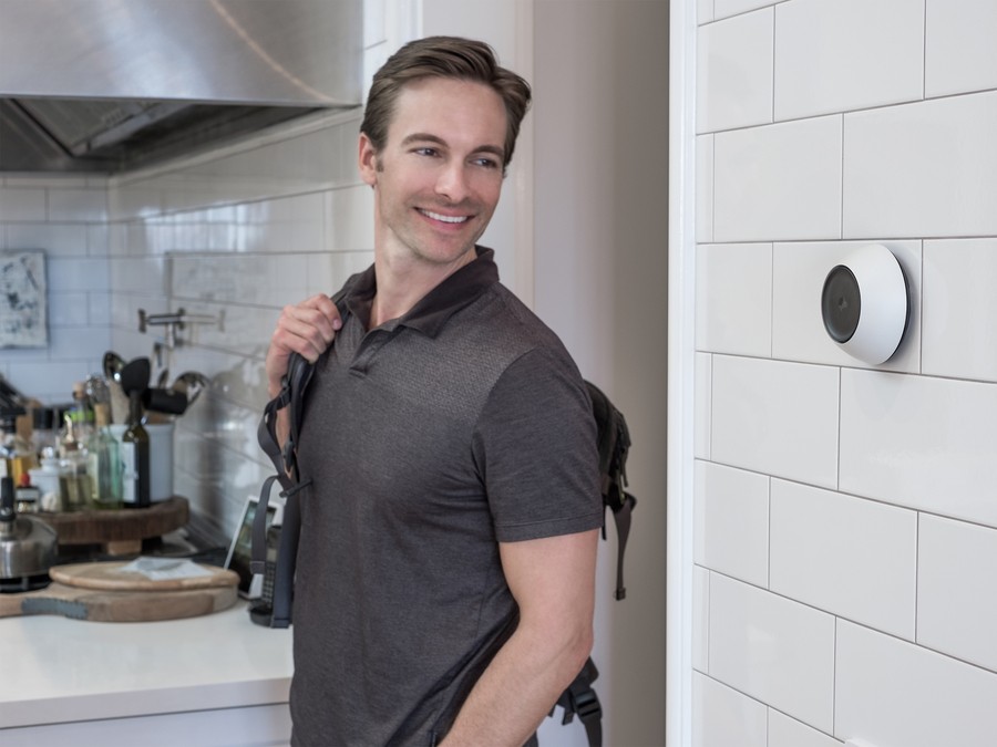 A man walking into a kitchen featuring a wall-mounted Josh Micro.