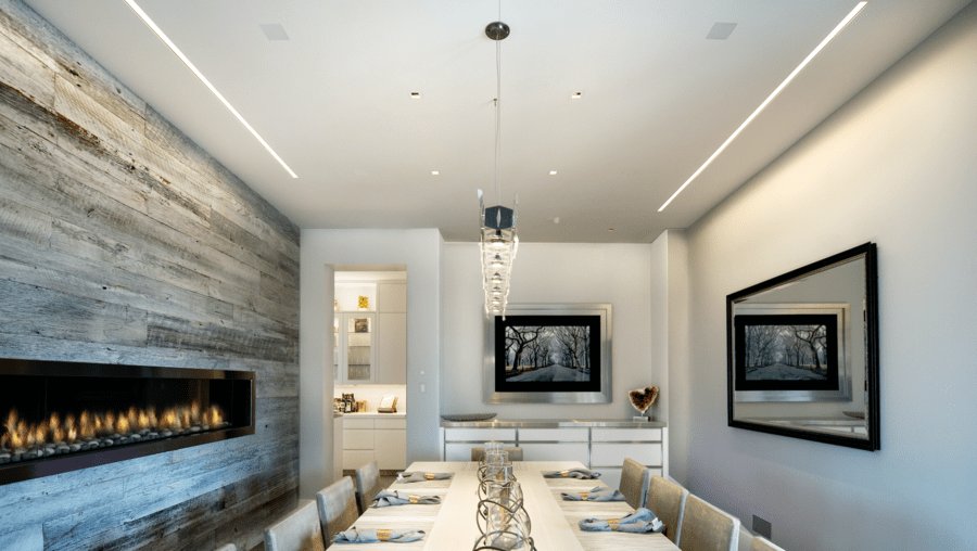 A luxury dining room with in-ceiling Sonance speakers.