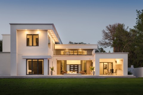 The exterior of a luxury home featuring Lutron lights.