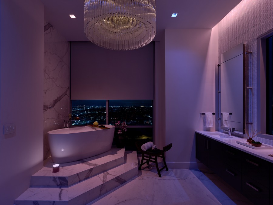 A residential bathroom illuminated by purple lights in a lighting control system.