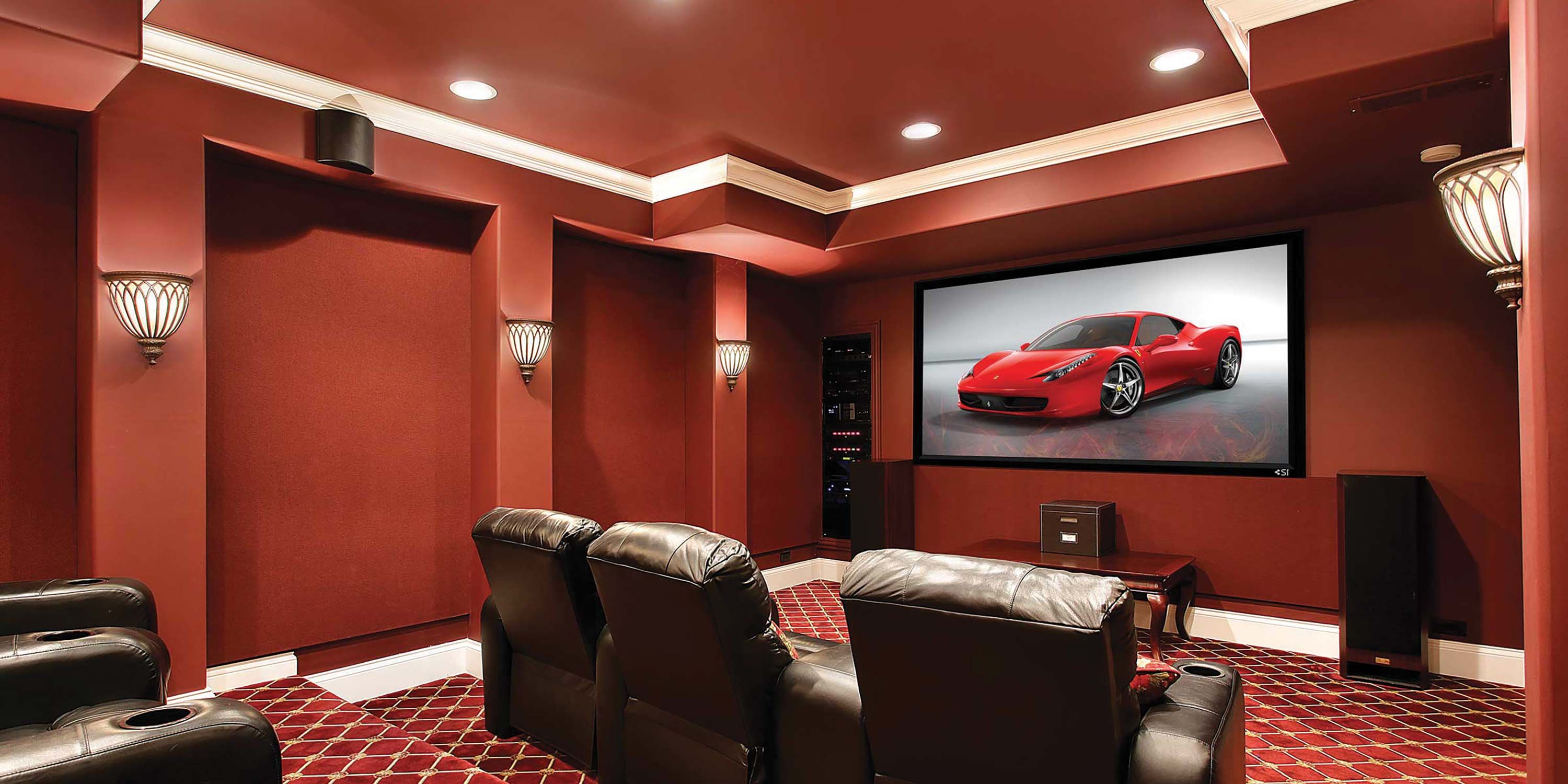 condo theather, red walls, car on screen