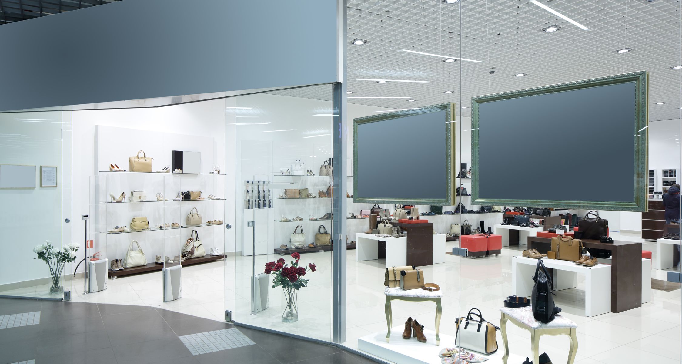 retail space, white walls and floor, large screens